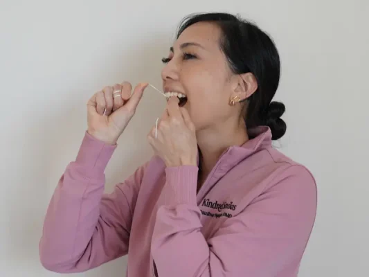 Dr. Pauline flossing her teeth